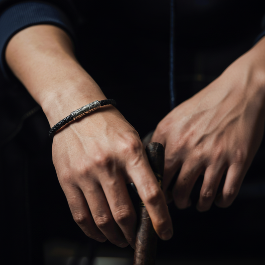 Men’s black braided leather bracelet with engraved metal clasp, minimalist rugged design worn on wrist – AEXON SMITH