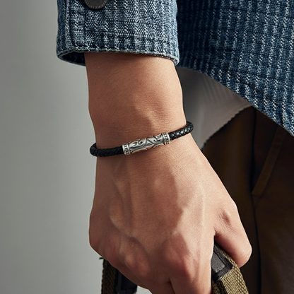 black leather bracelet with engraved stainless steel bar centerpiece on wrist