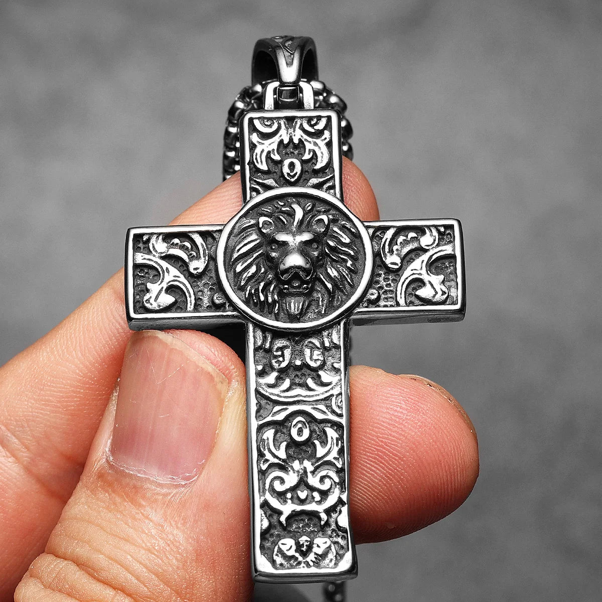 Close up of stainless steel lion cross pendant necklace