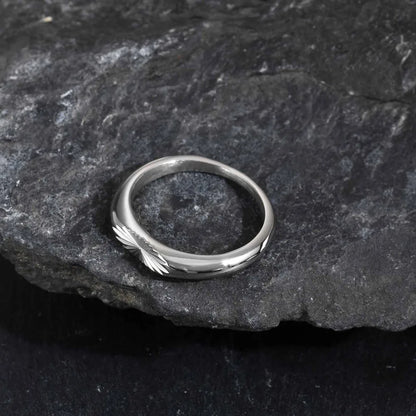 Close up of engraved sunburst pattern stainless steel ring