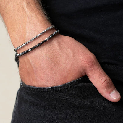 men's hematite bead bracelet with chain layer on a wrist