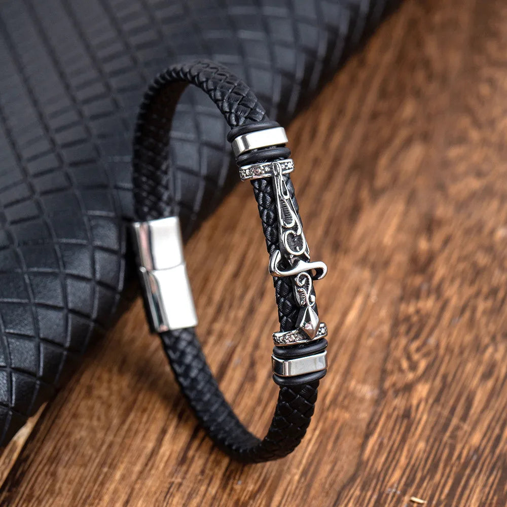 norse warrior sword bracelet with braided leather band