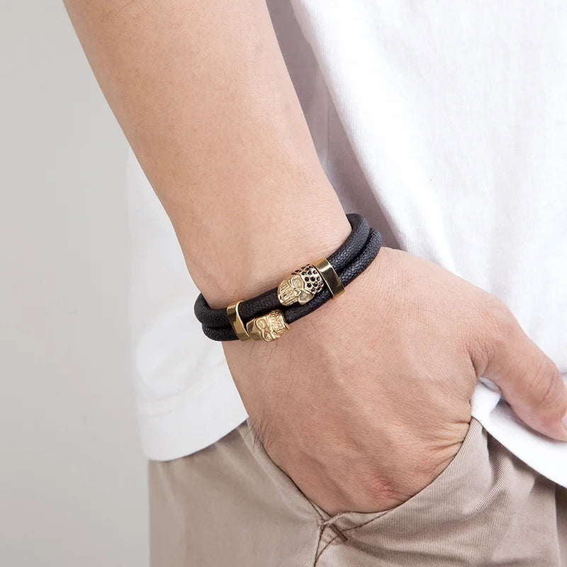 wrist wearing a men's biker skull bracelet made with black textured leather