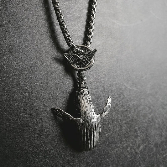 Close up of 52Hz whale pendant necklace on stainless steel chain